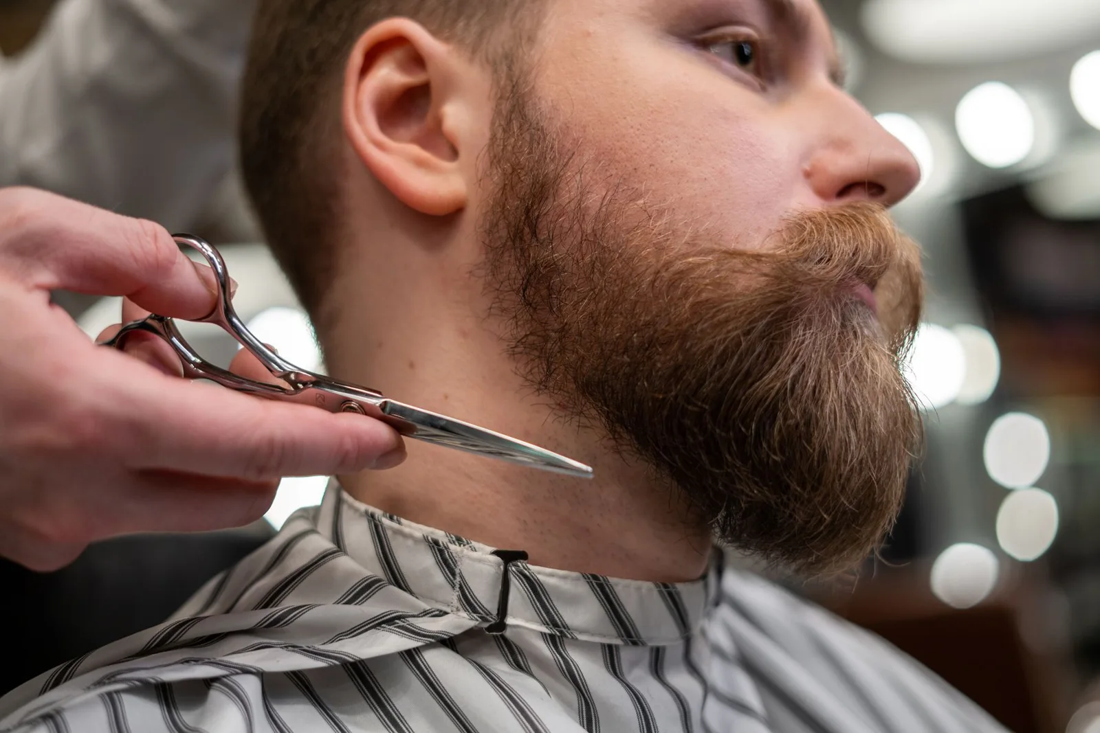Close view of a beard being shaped