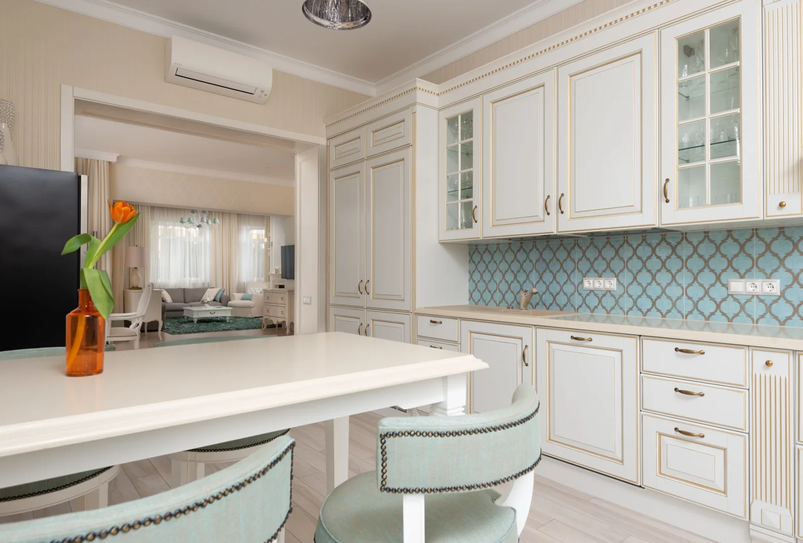 A bright kitchen with a clean island and dining area