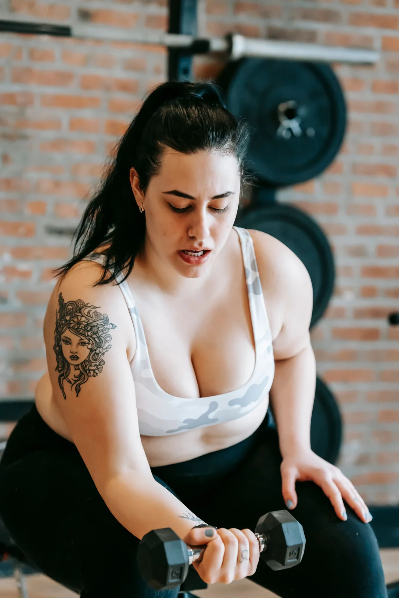 A person training with a dumbbell in a gym