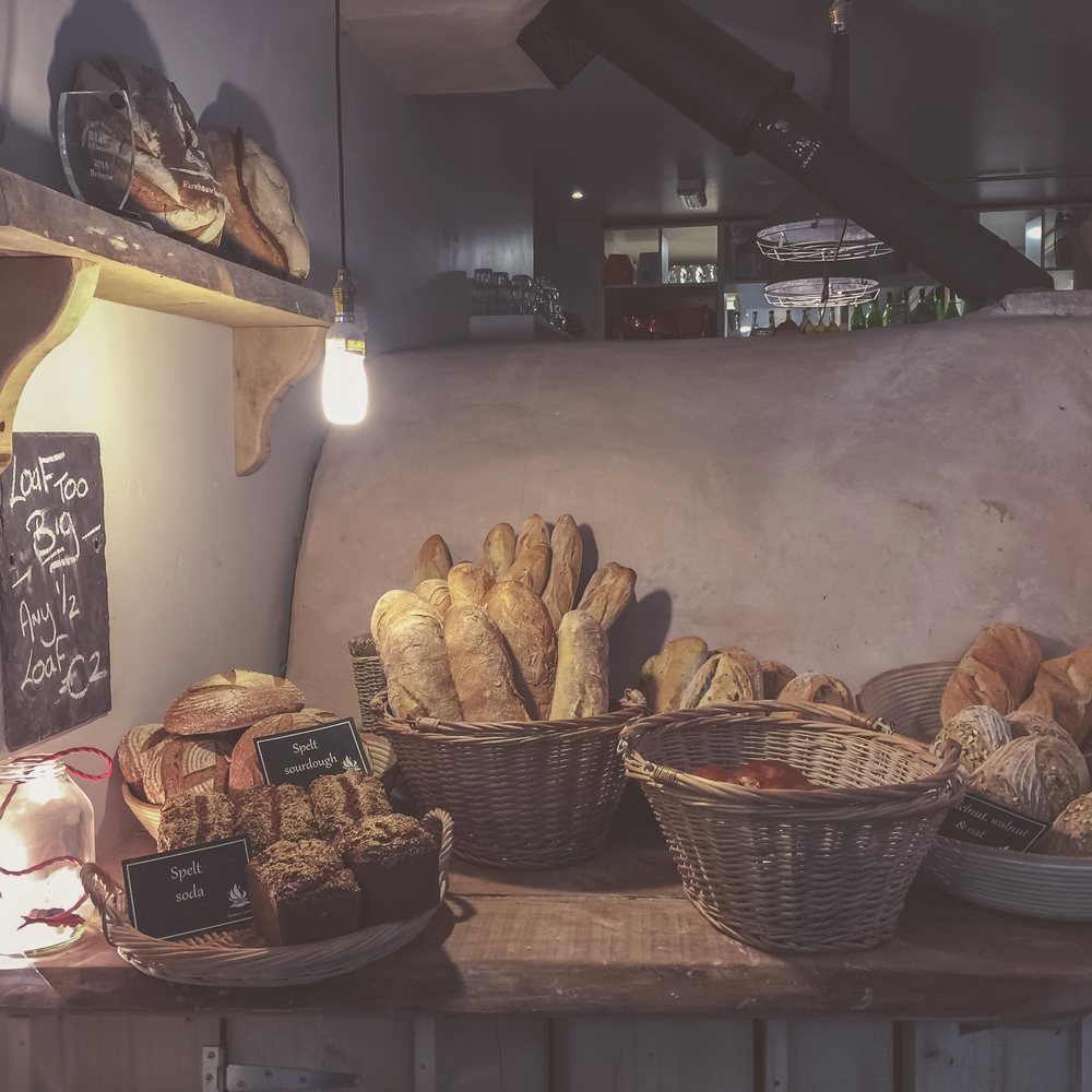 Loaves and baskets on a bakery counter.