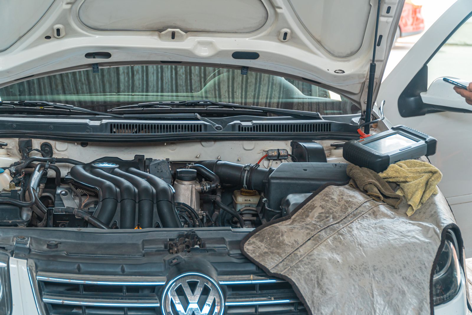 An open engine bay lit by a work lamp during a repair.