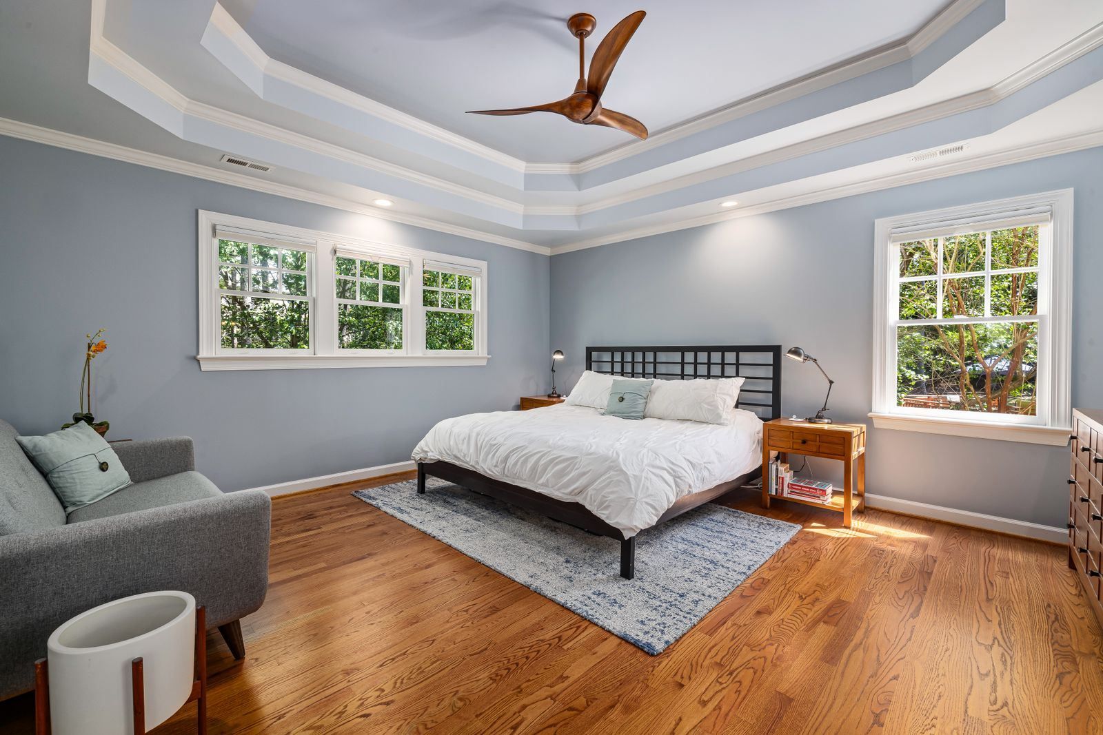 Blue-gray bedroom with painted trim and daylight