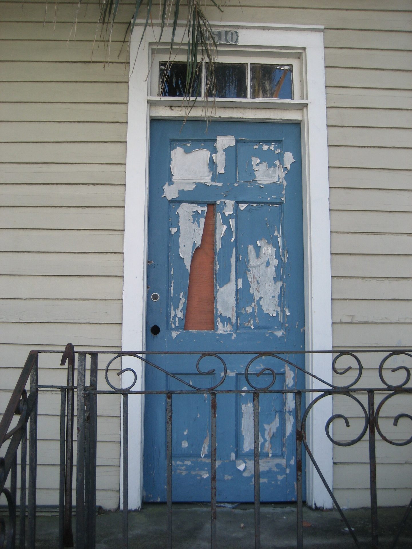 Blue coating peeling from a wooden door
