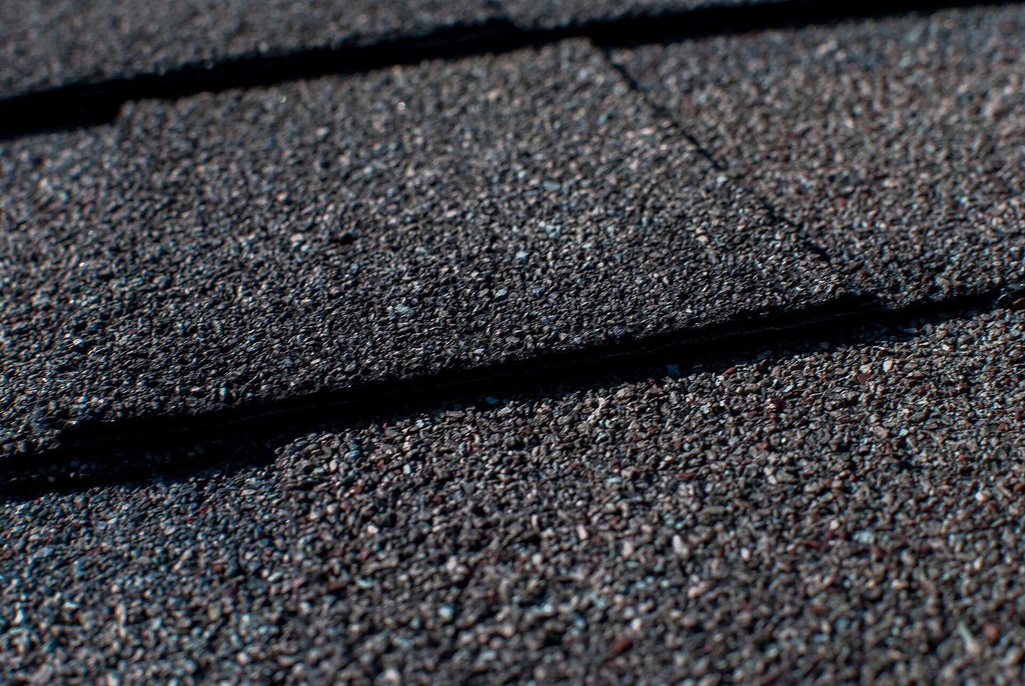 Close-up of the mineral granules on overlapping asphalt shingles