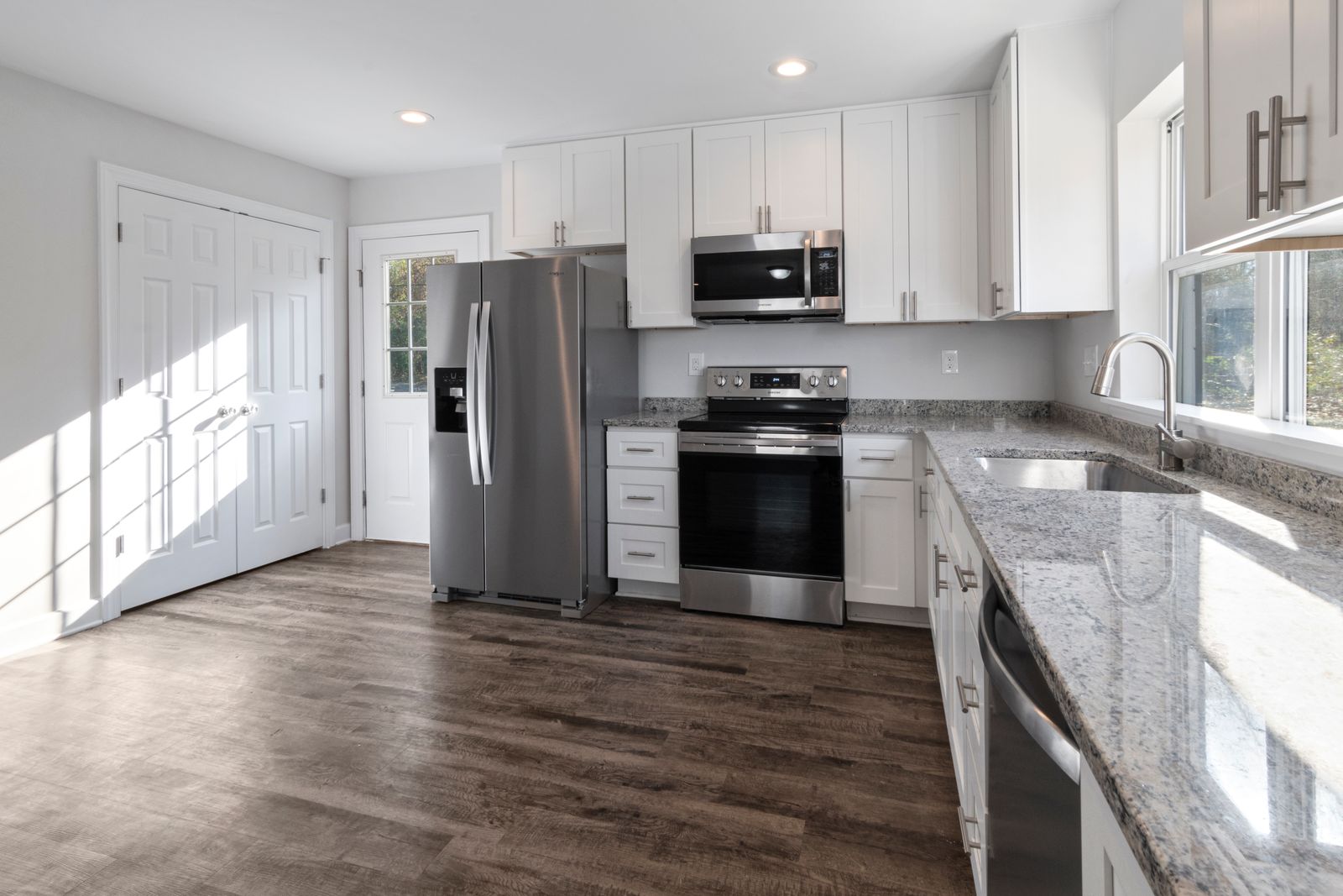 Finished cabinetry and appliances along the working wall of the kitchen.