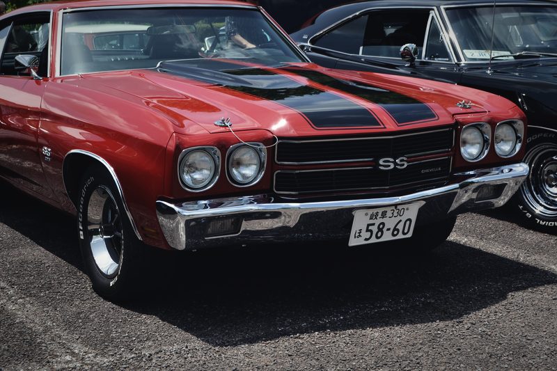 A red 1970 Chevrolet Chevelle SS with black stripes, photographed from the front three-quarter.