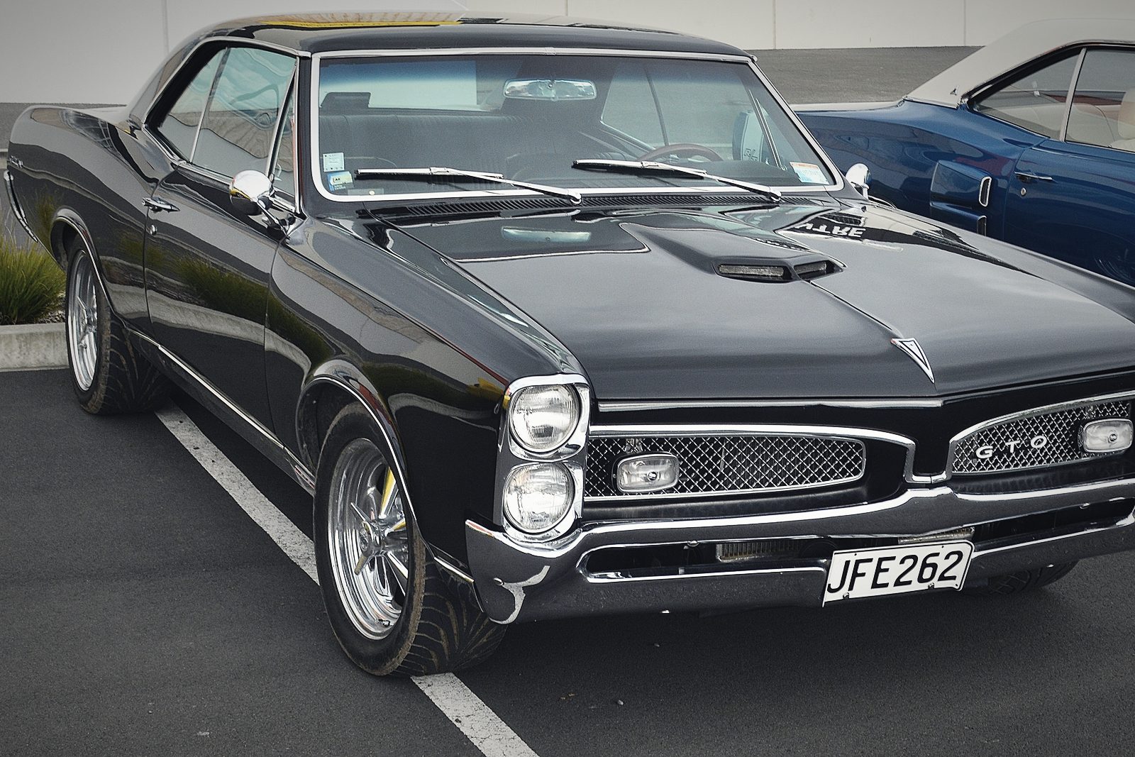 A black 1967 Pontiac GTO photographed from the front three-quarter.