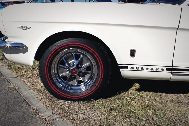 Show: Wheel and sill detail. Red-line tires are correct for the year and we keep them on it.
