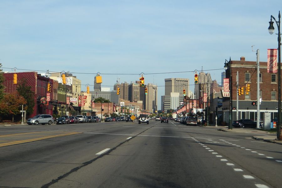 Michigan Avenue running east through Corktown with the downtown Detroit skyline at the end of it.